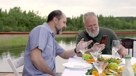 Two-Men-Having-Dinner-Or-Lunch-Outdoors
