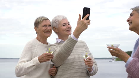Three-Lovely-Serior-Women-Dancing-And-Taking-Selfies-While-They-Have-A-Drinks-1