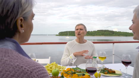 Drei-ältere-Frauen-Beim-Abendessen-Und-Getränken-Im-Freien