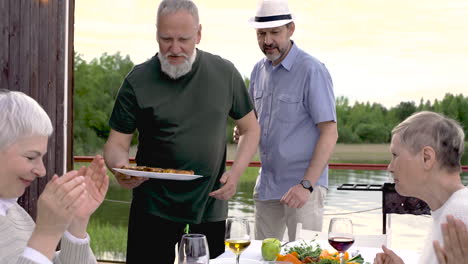 Two-Senior-Friends-Are-Serving-The-Dinner-Outside