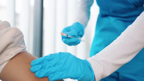 Close-Up-Shot-Of-Healthcare-Worker-Specialist-Hands-In-Protective-Gloves-Making-Vaccination-To-Patient,-Nurse-Hand-Injecting-Vaccine-Into-Patient-Arm-In-Hospital-Lab,-Vaccination,-Injection-Concept