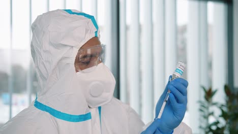 Close-Up-Concept,-Side-View-Of-Healthcare-Worker-Lab-Specialist-In-Protective-Suit-Filling-A-Syringe-With-Coronavirus-Vaccine