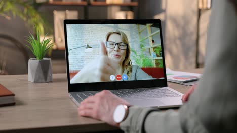 Female-Speaking-On-Video-Conference-On-Laptop-With-Cheerful-Woman-In-Room