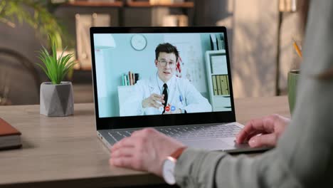 Girl-Speaking-On-Video-Chat-With-Male-Physician-On-Laptop-While-Sitting-In-Room