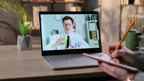 Female-Having-Online-Consultation-With-Physician-By-Video-Conference-Indoor-And-Writing-Down-Treatment
