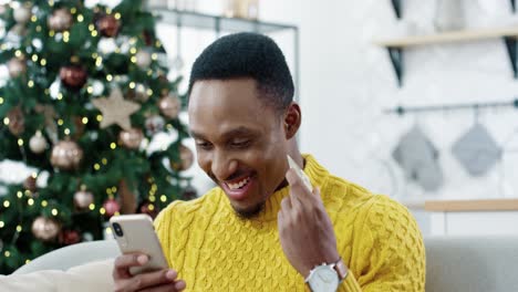 Close-Up-Portrait-Of-Happy-Guy-Making-Xmas-Sale-Purchase-Online-On-Smartphone-With-Happy-Face