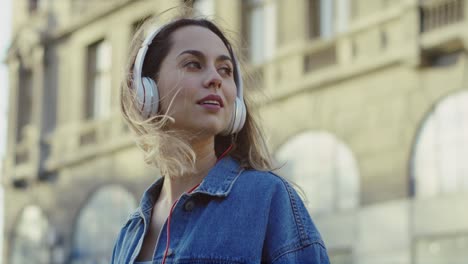 Closeup-Attractive-Young-Woman-Using-Headphones