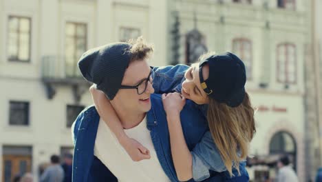 Couple-Of-Hipsters-Hugging-And-Having-Fun-While-Walking