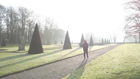 A-girl-is-walking-through-the-morning-sunlight-at-the-park