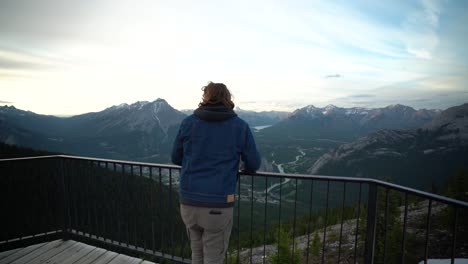 Young-handsome-man-looking-out-over-Jasper-National-Park,-Alberta,-Canada
