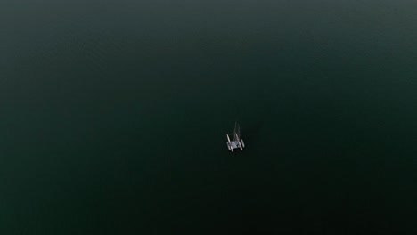 Aerial-Flight-Over-a-Sailboat,-Lake-Gruyère,-Switzerland