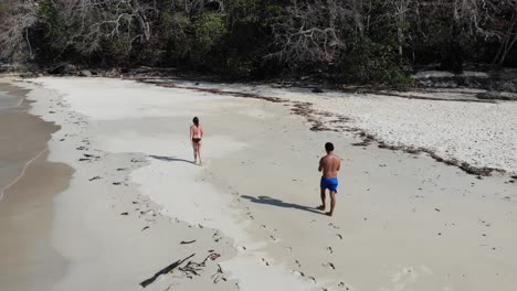 Panama-in-February-drone-shoots-Contadora-Island-guys-walking,-recording