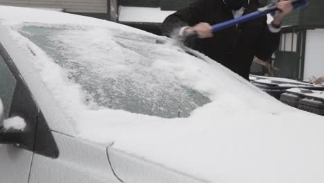 Scraping-Off-The-Thick-Ice-On-The-Car-Windshield---Close-Up-Shot