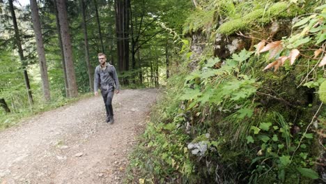 Man-walking-through-Pokljuka-Gorge-in-Slovenia-during-spring-in-the-Triglav-National-Park