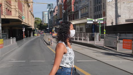 Woman-wearing-mask-during-covid19-crossing-Flinders-St