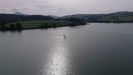 Aerial-Flight-Over-a-Sailboat,-Lake-Gruyère,-Switzerland-1