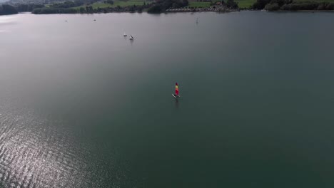 Aerial-Flight-Around-a-Sailboat,-Lake-Gruyère,-Switzerland
