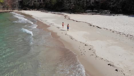 Panama-in-February-drone-shoots-Contadora-Island-guys-walking,-recording-2