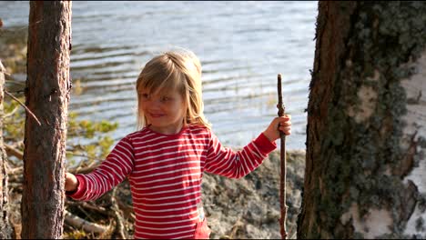 Cute-and-happy-four-year-old-girl-smiling-by-the-water,-static-portrait-shot-in-slow-motion