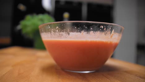 The-cook-picks-up-a-bowl-of-gazpacho
