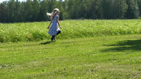 Happy-summer-girl-running-in-green-grass-landscape,-freedom-concept