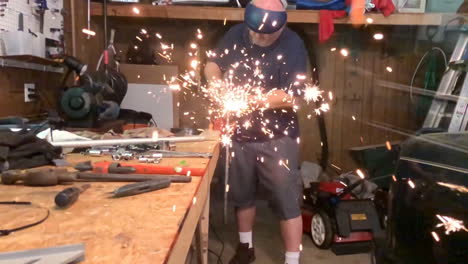 Man-welding-in-garage-workshop-slow-motion