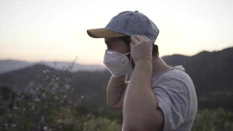 Slow-motion-young-man-wearing-a-mask,-nature-background,-sunset,-static-shot