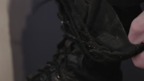 Unlacing-And-Taking-Off-The-Black-Boots---Close-Up-Shot