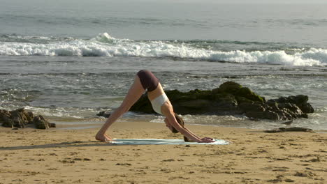 An-attractive-young-woman-practicing-yoga-on-a-beautiful-California-beach-1