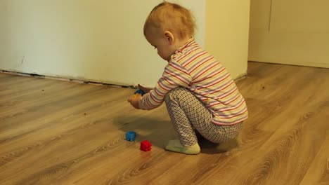 Little-girl-picking-playing-with-blocks