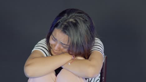 Young-depressed-asian-girl-alone-in-room-is-crying,-close-up