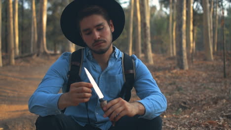 Explorer-in-the-woods-playing-with-a-knife