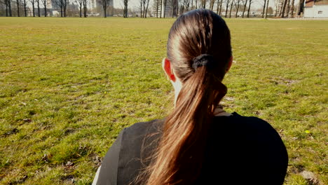 Close-up-scene-of-the-adult-woman-is-meditating-at-the-quiet-park