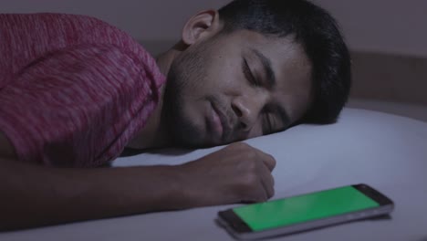 Sleeping-young-teenager,-Concept-showing-of-ringing-alarm,-Getting-message-or-mail-on-Green-screen-Mockup-of-Mobile-While-sleeping-at-Night-Time