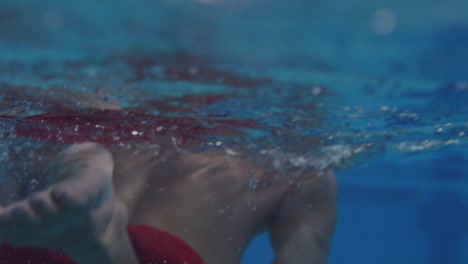 Underwater-shot-of-man-swimming-with-breast-stroke-technique