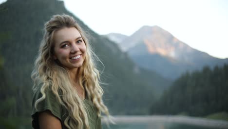 Slow-Motion-Shot-of-a-happy-beautiful-blonde-female-overlooking-a-gorgeous-scene-in-the-mountains-1