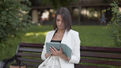 Beautiful-girl-working-remotely-from-a-park-bench