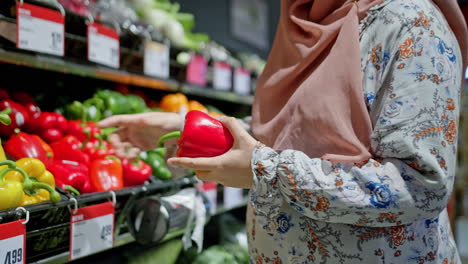 Muslim-Young-Pregnant-Woman-Close-Up-Belly-Shopping-Searching-in-Vegetables-Section-in-Fancy-Grocery-Store-Colorful-Bright-in-Slow-Motion