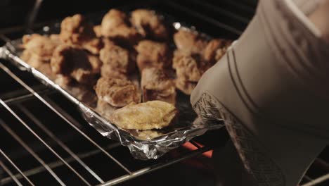Fried-Chicken-Placed-Inside-The-Oven-For-Baking---Close-Up-Shot