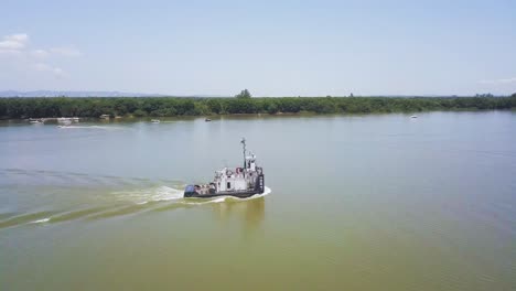 Altes-Rostiges-Boot-Fährt-Auf-Fluss-In-Brasilien,-Langsames-Zoomen-Aus-Der-Luft-Heraus-Enthüllt-Die-Landschaft