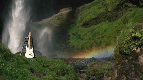 Man-playing-guitar-in-front-of-a-beautiful-waterfall-in-Iceland-8