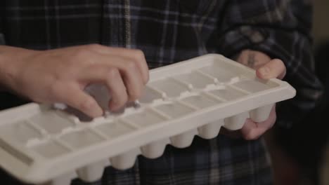 A-Woman-Getting-A-Piece-Of-Frozen-Ice-Cube-On-The-Ice-Rack---Close-Up-Shot