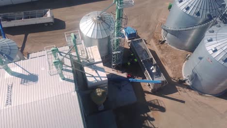 Drone-aerial-view-of-a-trailer-being-loaded-at-an-agribusiness-that-exports-cover-seeds-located-in-Nebraska-USA