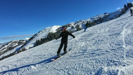 Teenage-boy-having-fun-during-snowboarding-on-a-sunny-day