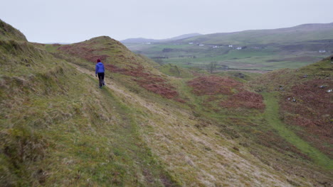 Seguimiento-De-Seguimiento-De-Una-Niña-Feliz-Caminando-Por-La-Ruta-De-Senderismo-En-Fairy-Glen-En-Escocia,-Isla-De-Skye