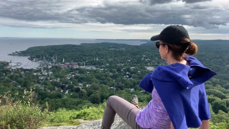4K-Woman-gazing-down-on-Camden-Maine-from-Atop-Mount-Battie