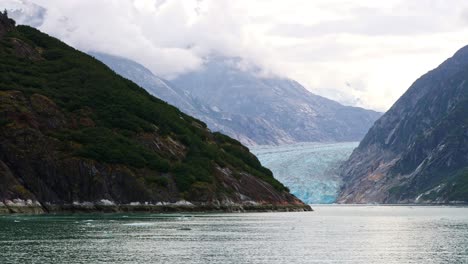 Tilt-down-revealing-Dawes-Glacier-meeting-Endicott-Arm-Fjord-in-Alaska