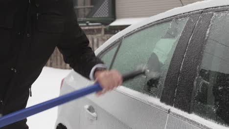 Scraping-The-Ice-Frost-Forming-In-The-Window-Frame-Of-The-Car---Close-Up-Shot