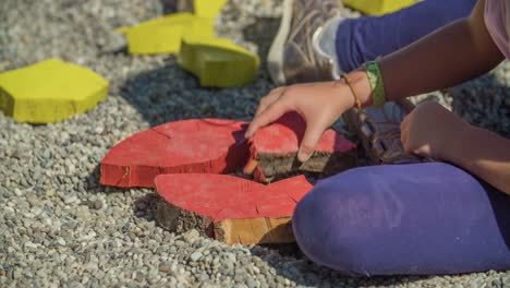 Little-girl-plays-with-the-colorful-wooden-blocks-on-playground