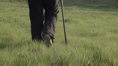 Woman-walking-with-walking-stick-in-countryside